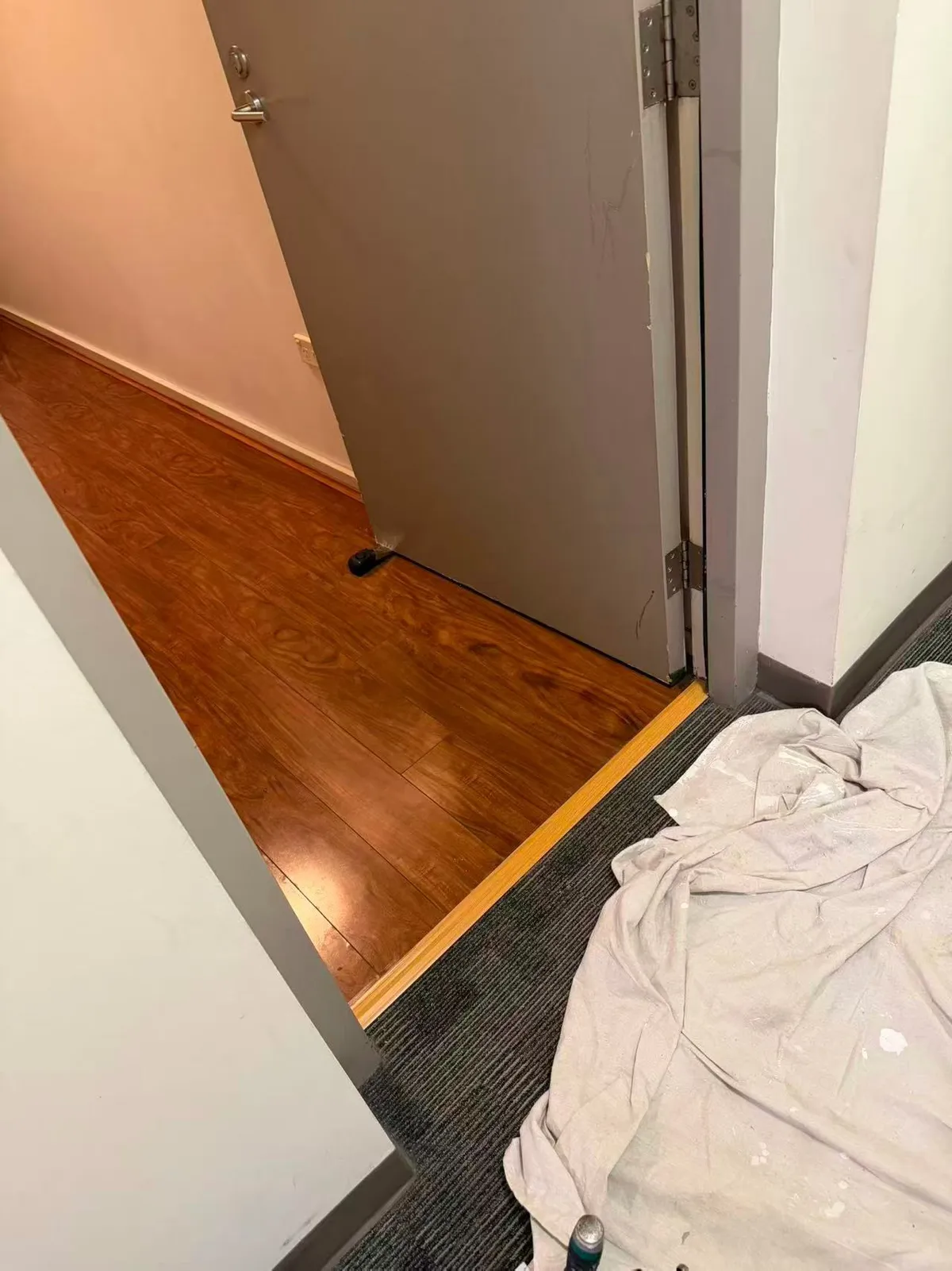 Open apartment door showing the lower edge